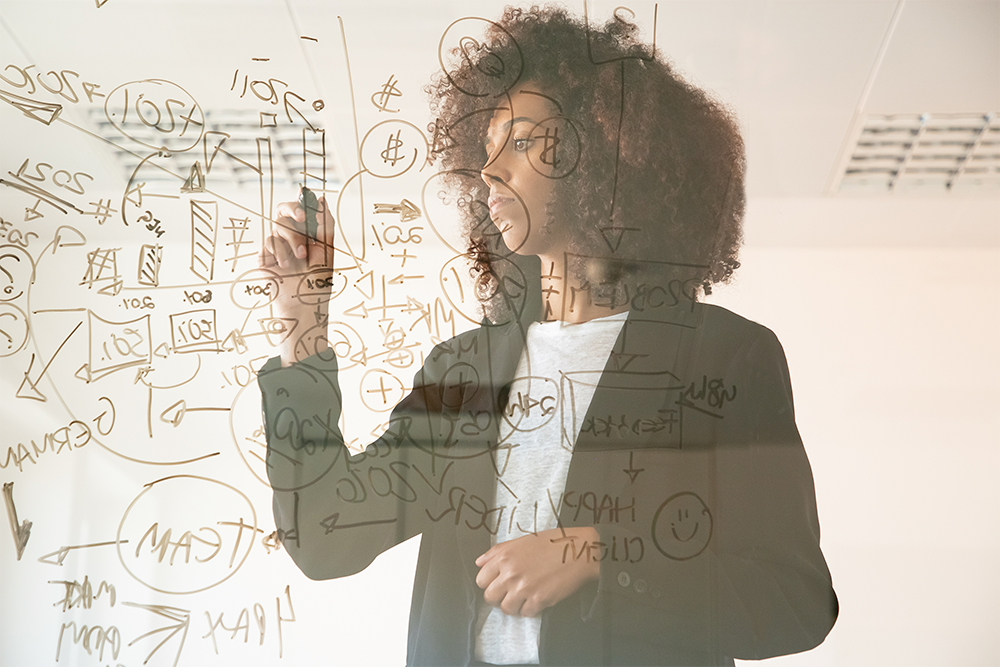 Woman explaining visuals on transparent board